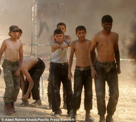 These Palestinian boys were photographed taking part in a military exercise at one of the summer camps on June 9, in an area called Rafah